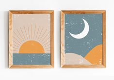 two framed art prints with the sun and moon on them in wood frames against a white wall