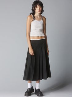 *This item is excluded from all promotions/discounts. Low-waisted pleated skirt with a raw edge waistband. The drop waist and raw details turn the classic pleated skirt into a more sophisticated look. Secured by a zipper, perfect for belt layering. 55% Cotton 45% Tencel UWSK-1166 Imported Model is 5'9" and wearing a si Classic Cotton Pleated Waist Skirt, Classic Cotton Pleated Skirt With Accordion Pleats, Classic Skirted Bottoms With Pleated Waist, Classic Cotton Pleated Lined Skirt, Daywear Relaxed Pleated Skirt, Daywear Pleated Waist Relaxed Skirt, Daywear Pleated Skirt With Relaxed Fit, Daywear Pleated Waist Midi Skirt, Daywear Midi Skirt With Pleated Waist