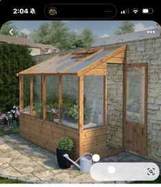 an image of a small wooden greenhouse