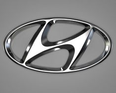 the logo for an automobile company on a gray background with black and white lines in the center