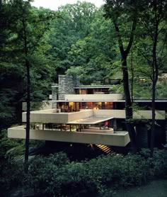 a modern house in the woods surrounded by trees