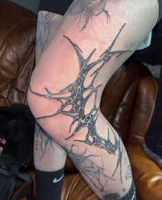 a man's leg with tattoos on it