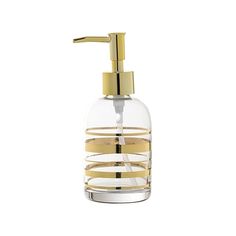 a glass soap dispenser with gold accents