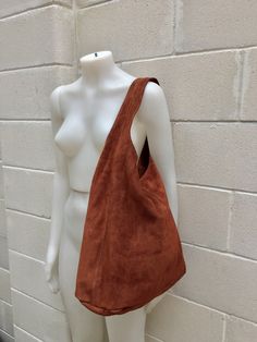 Slouch bag. LARGE tote leather bag in dark camel BROWN. Natural genuine SUEDE leather. WITH ZIPPER. NOT LINED. Tobacco color. This soft shoulder bag is comfortable to wear due to the wide strap. This model is closed with a zipper. Large enough to fit most tablets, books etc. The color is best represented on the first 4 pictures. The bag that the model wears is the ligher shade of camel brown Width : 42cm - 16,5 in Height at the center: 34 cm - 13, 5 inc Total height : 65,5 cm - 26 inch This bag Rectangular Suede Bag For Fall, Brown Suede Shoulder Bag With Large Capacity, Rectangular Brown Hobo Bag With Suede Lining, Brown Hobo Bag With Suede Lining For Shopping, Brown Suede Bag With Zipper Closure, Brown Suede Rectangular Hobo Bag, Brown Suede Rectangular Shoulder Bag, Cognac Suede Bag For Daily Use, Soft Leather Suede Bags For Fall