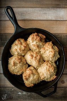 biscuits in a cast iron skillet on a wooden table