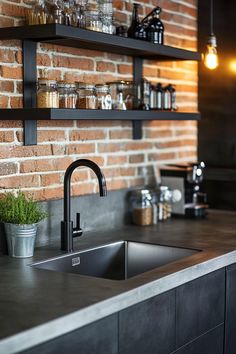 a kitchen sink sitting under a window next to a brick wall with shelves above it