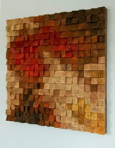 an art piece made out of wood with red and yellow squares on the back side