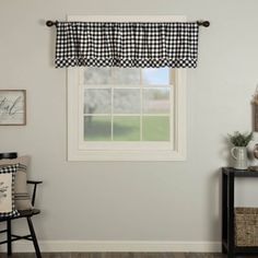 a window with a black and white checkered valance hanging from it's side