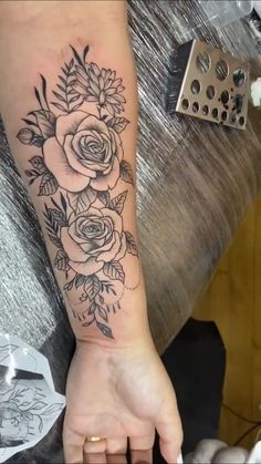 a woman's arm with flowers on it