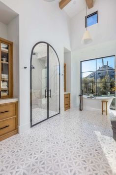 a large bathroom with a walk in shower next to a window