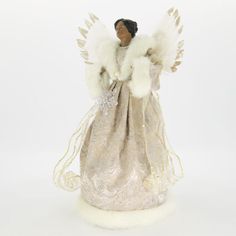 an angel figurine with white fur and wings on it's back, against a white background