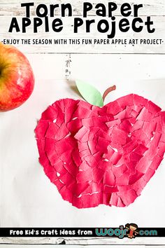 an apple made out of torn paper on top of a piece of paper next to an apple