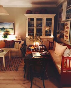 a living room filled with furniture and candles