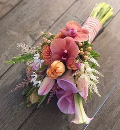 a bouquet of flowers sitting on top of a wooden table