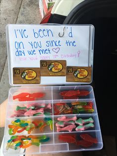 a box filled with lots of different types of gummy bears next to a sign that says i've been told on you since the day we met