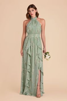 a woman wearing a green dress with flowers on it