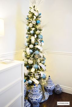 a decorated christmas tree with blue and white ornaments