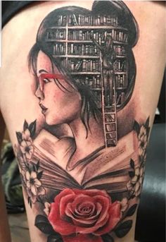 a woman with a book and rose tattoo on her thigh