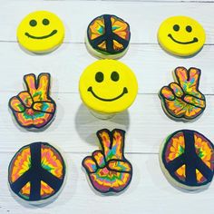 decorated cookies with smiley faces and peace signs