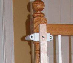 a cat sitting on the floor in front of a wooden door with two white handles