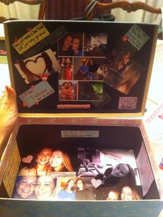 an open box with pictures and writing on the inside that is filled with people's photos