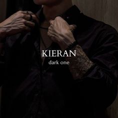 a man is tying his tie in front of the camera and text that reads, kieran dark one