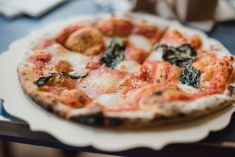 a small pizza sitting on top of a white plate