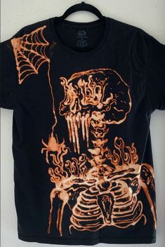 a black t - shirt with an orange skeleton on it