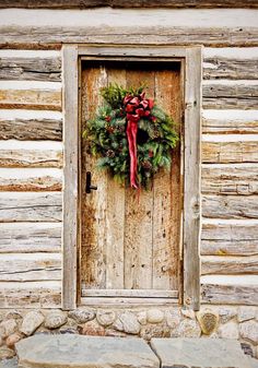 a wooden door with a christmas wreath on it