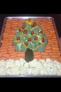 a christmas tree made out of carrots and broccoli in a plastic container