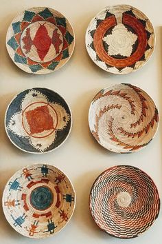 four bowls with different designs on them are arranged in a gridded pattern, and one is empty