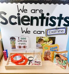 a table with scissors, books and other items on it that say we are scientist's