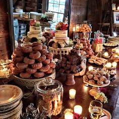 a table topped with lots of cakes and donuts on top of eachother