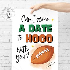 a hand holding up a poster that says can i score a date to hog with you?