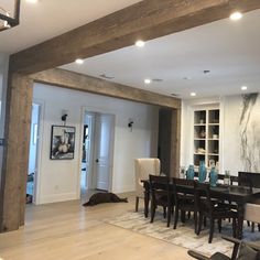 a dining room table and chairs in front of a fireplace