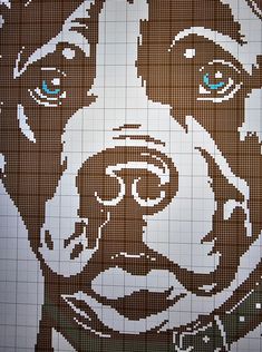 a dog's face is made out of brown and white squares with blue eyes