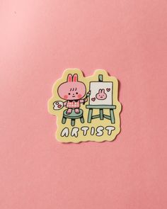 a sticker with the words artist written on it and a cartoon character in front of an easel