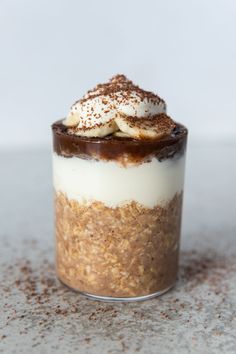 a dessert in a glass topped with whipped cream and chocolate