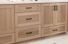 a bathroom with wooden cabinets and white counter tops