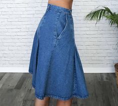 "✿ Adorable late 80s denim pleated skirt. Above knee length with an ultra high waist, dual front side pockets and button up side closures. Two large inverted pleats down front and back that lightly puff and add so much cuteness to this skirt! Medium wash blue denim. Belt loop holes so you can add your favourite belt. We love how a striped vintage turtleneck looks tucked into it. Excellent vintage condition. Cutest find! ✿ Labelled size: Vintage 8 Fits like: Modern day US 4 / Ladies Small / Waist High Waist Pleated Denim Blue Denim Skirt, High Waist Pleated Denim Blue Skirt, High Waist Pleated Denim Skirt, High Waist Pleated Denim Skirt In Blue, High Waist Medium Wash Pleated Skirt, High Waist Pleated Skirt In Medium Wash, Tan Wool Coat, Vintage Turtleneck, Denim Pleated Skirt