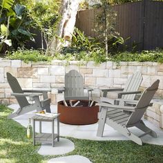 an outdoor fire pit surrounded by lawn chairs