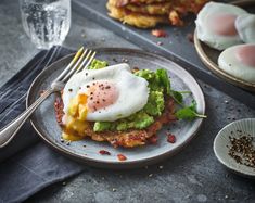 an egg and avocado sandwich on a plate with a fork next to it