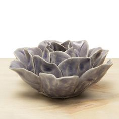 a white bowl sitting on top of a wooden table