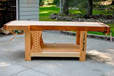 a wooden workbench sitting on top of a driveway