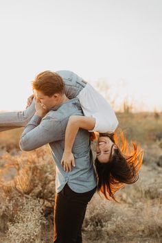 a man carrying a woman on his back in the desert