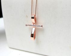 This artistic design cross pendant is made of solid gold and decorated with natural diamonds. It contains 8-10 round brilliant cut diamonds. You can choose 14K or 18K yelllow, white or rose gold. A modern cross for women which is not only a christian symbol but also a beautiful piece of jewelry. A meaningful gift for you and your loved ones. A dainty cross which is distinguished for its modern design. DETAILS oMaterials ⁃ 14K or 18K gold         Yellow, White or Rose Gold   oHeight ⁃ 2.4mm / 0.9 Anniversary Diamond Pendant Cross Necklace, Diamond Crucifix Necklace With Diamond Accents, Crucifix Diamond Necklace With Diamond Accents As Gift, Diamond Cross Pendant Necklace With Accents As Gift, Crucifix Diamond Necklace With Diamond Accents For Gift, Diamond Crucifix Necklace With Accents As Gift, Rose Gold Cross Necklace With Diamond Accents, Diamond Cross Pendant Necklace With Pave Setting, Diamond Cross Pendant Necklace With Pave Setting For Gift