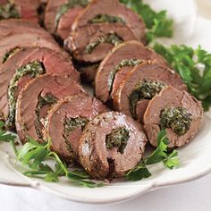 sliced meat on a white plate with parsley