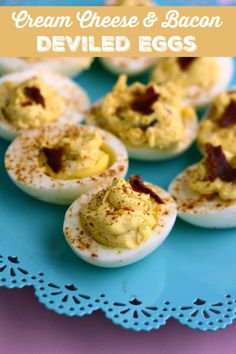 deviled eggs with cream cheese and bacon are on a blue plate