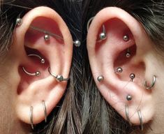 two people with piercings on their ears and behind them is an ear pin in the middle