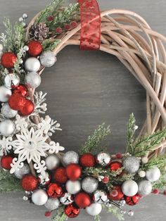 a christmas wreath with red, white and silver ornaments